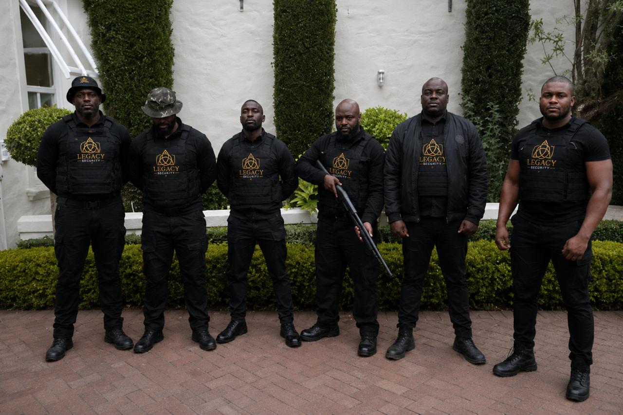 Legacy Security operators in branded armour on courtyard detail